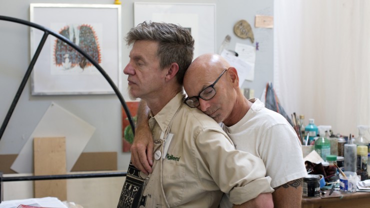 Ralph Thurlow kisses his husband, David Spiher, on the back during a visit to Spiher's artist studio in Oakland, Calif. on September 10, 2015. Both men are HIV-positive and Thurlow has AIDS-related dementia. (Photo by Erin Brethauer)